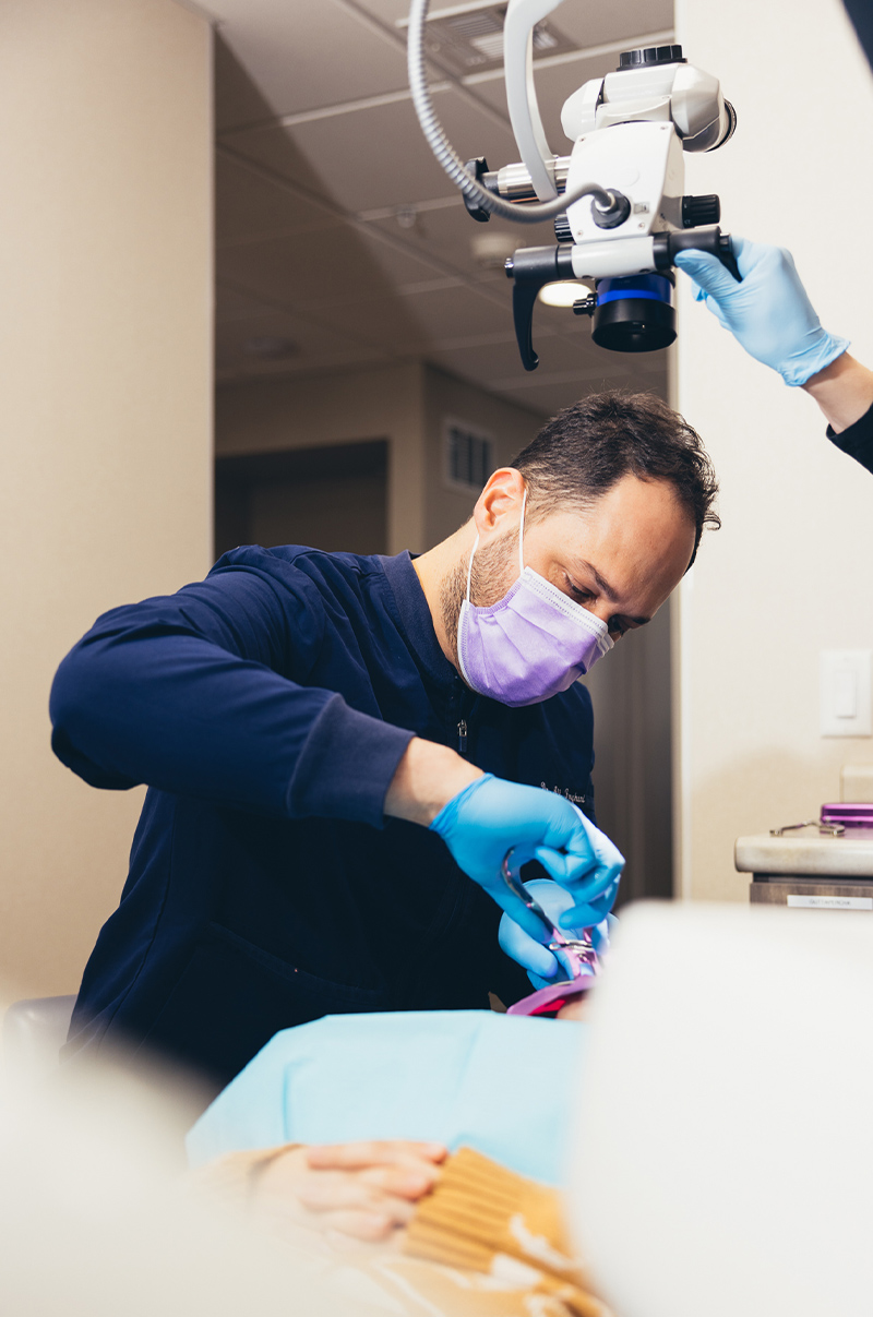Expert endodontist working on a patient.